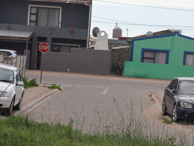 A street view showing the paved road, kerbing, and surrounding residential properties in the neighborhood.