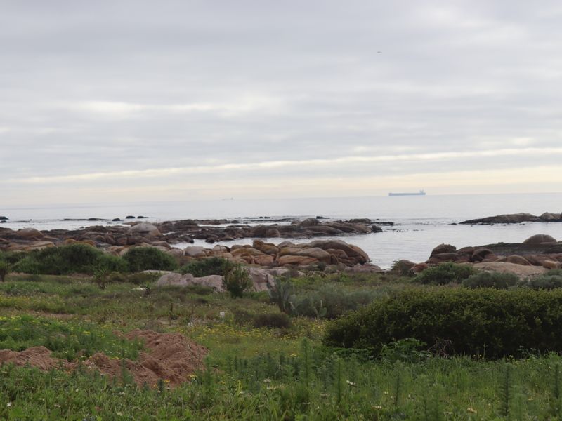 A scenic view of the rocky coastline and ocean, showcasing the natural landscape of the vacant residential property.