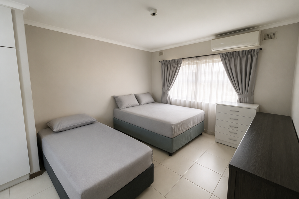 A well-maintained bedroom featuring tiled flooring, a built-in wardrobe, and a wall-mounted split-system air conditioner for climate control.
