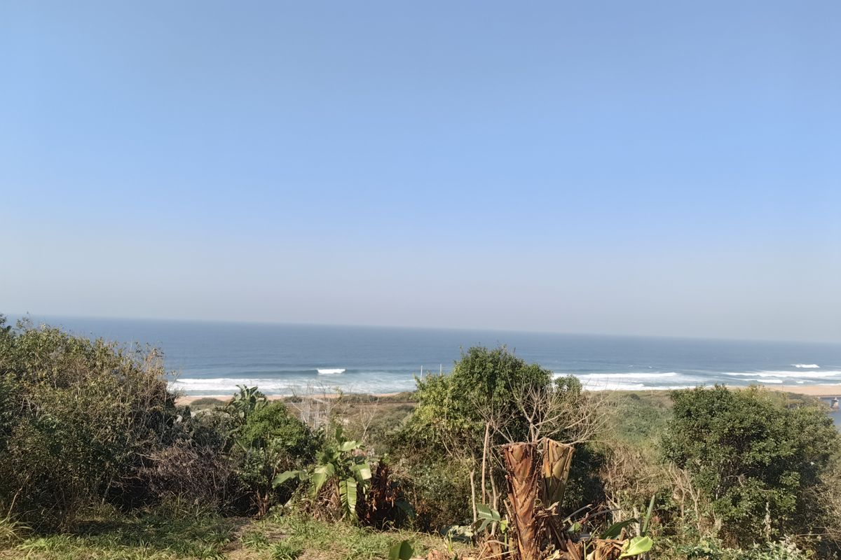 A scenic view overlooking the coastline and ocean, showcasing the natural landscape of the vacant residential property.