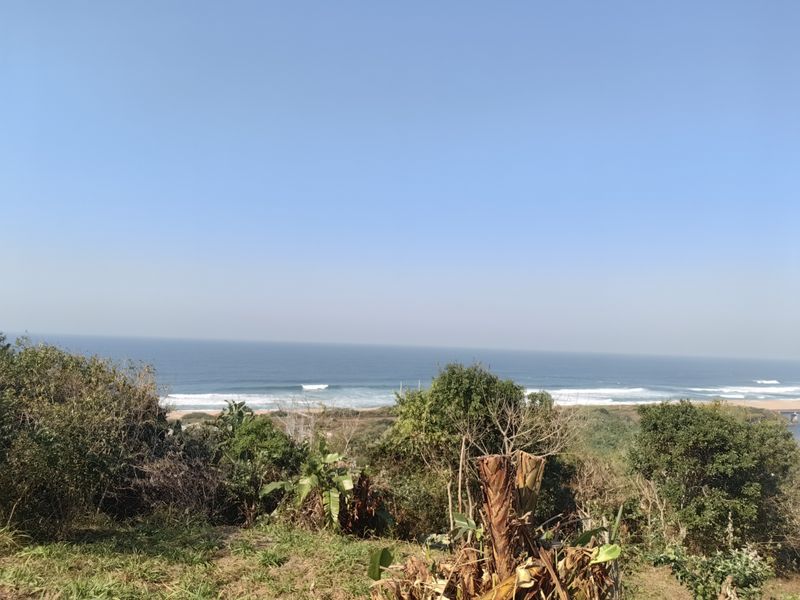 A scenic view overlooking the coastline and ocean, showcasing the natural landscape of the vacant residential property.