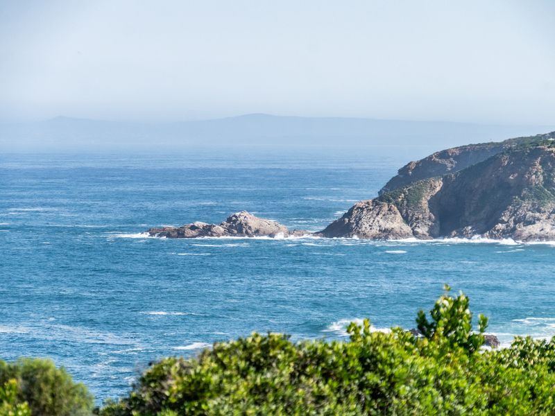A scenic coastal view featuring rocky cliffs and the ocean, showcasing the natural landscape surrounding the property.