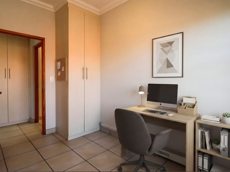 A functional home office featuring neutral tiled flooring, built-in storage cupboards, and coved ceiling detailing.
