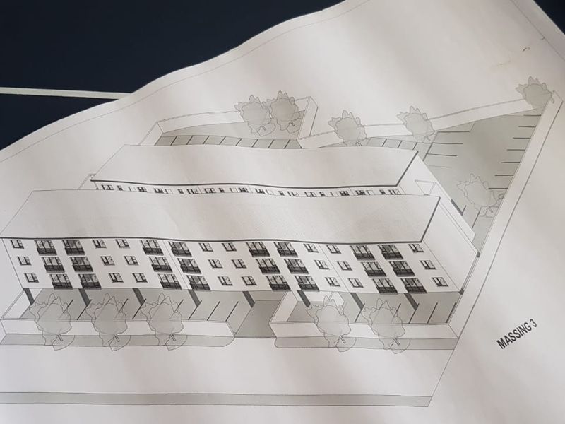 Architectural massing diagram showing the proposed residential building layout and site development plan.