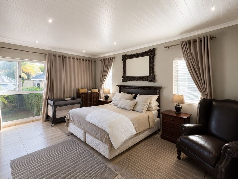 Spacious bedroom featuring a tongue and groove ceiling, recessed lighting, and large sliding glass doors that provide ample natural light.
