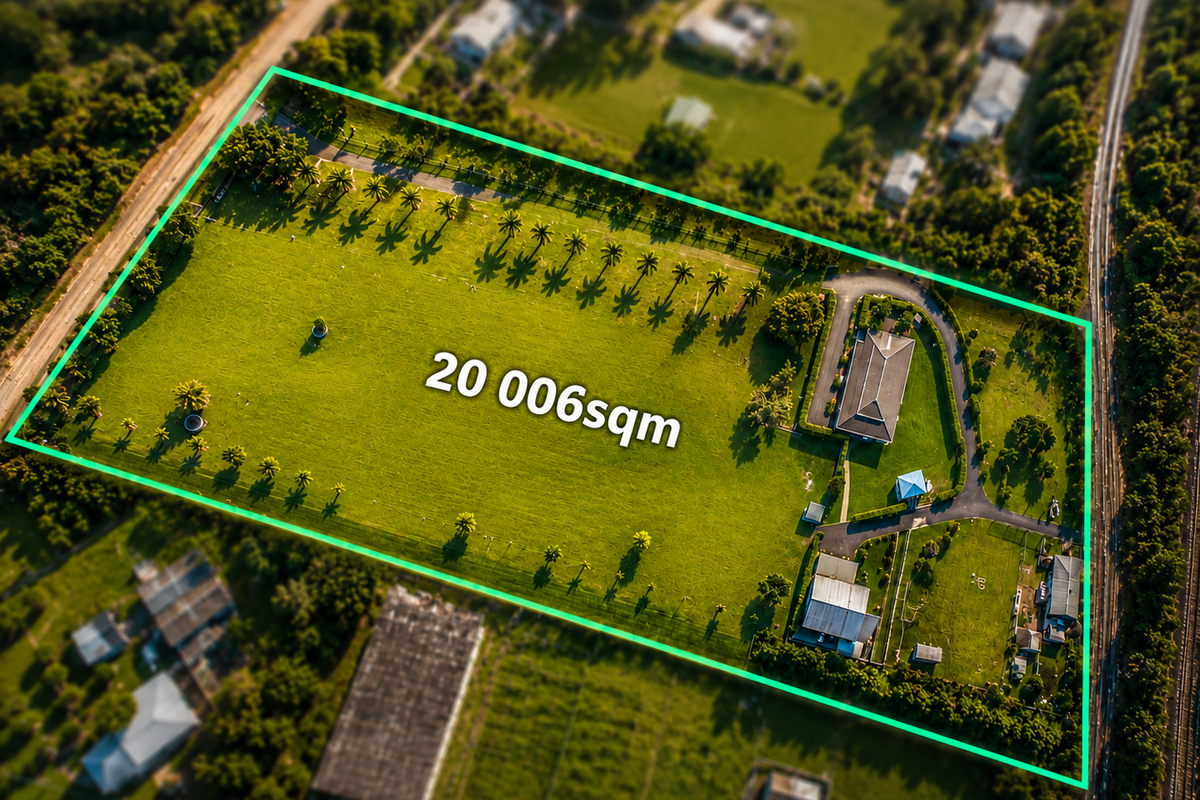 Aerial view of a large 20,006sqm property featuring a main residence, outbuildings, and extensive landscaped grounds with a paved driveway.
