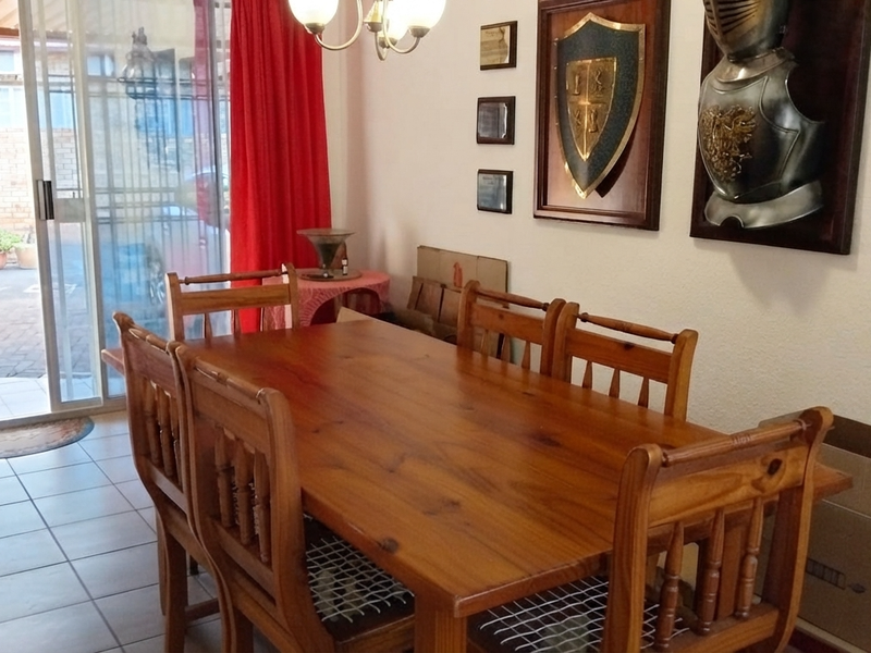 Dining area featuring tiled flooring and a sliding glass door providing access to the outdoor patio space.