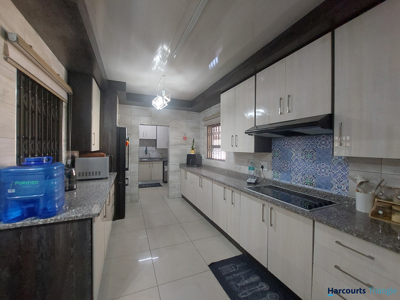 Modern kitchen featuring sleek white cabinetry, granite countertops, integrated hob with extractor fan, decorative tiled backsplash, and polished floor tiles.