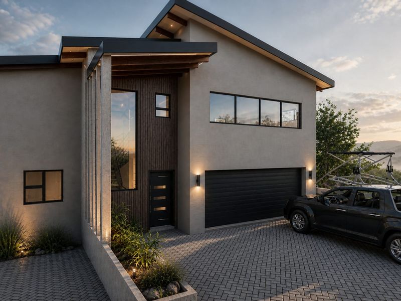Modern two-story residential facade featuring a paved driveway, integrated garage, and contemporary architectural finishes with timber accents and exterior lighting.