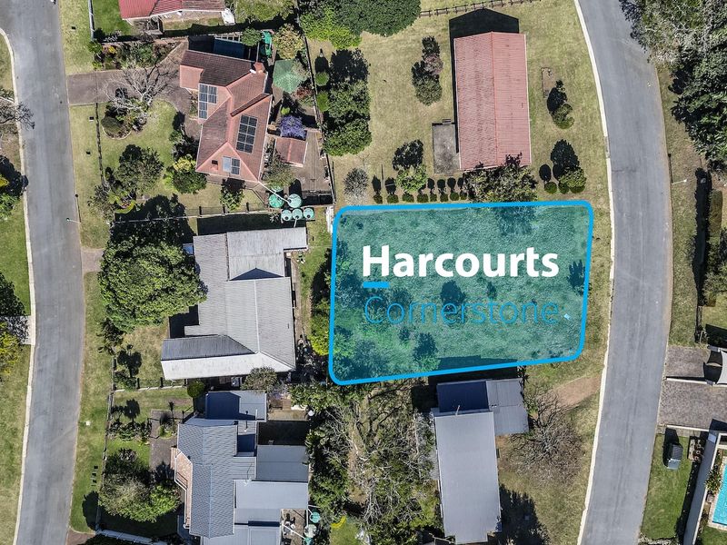 An aerial view of a vacant residential plot situated within an established neighborhood, highlighting the available land for potential development.