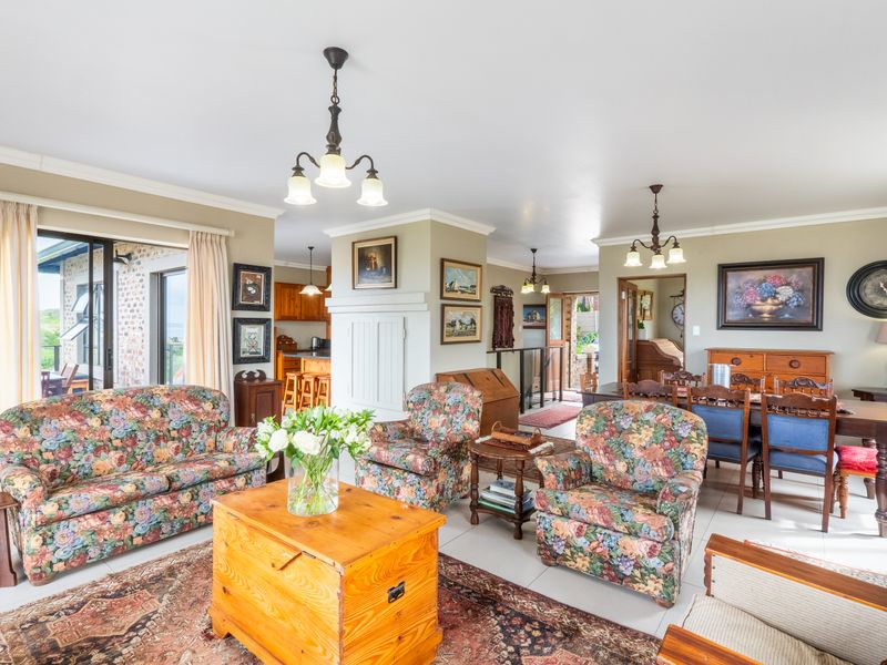 Spacious open-plan living and dining area featuring tiled floors, sliding doors to the patio, and an integrated kitchen space.
