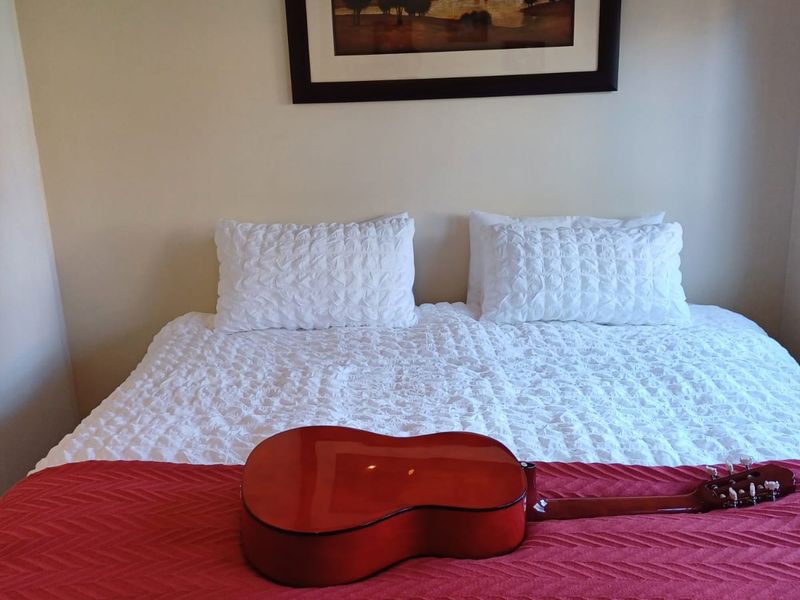 A standard bedroom space featuring neutral wall finishes.