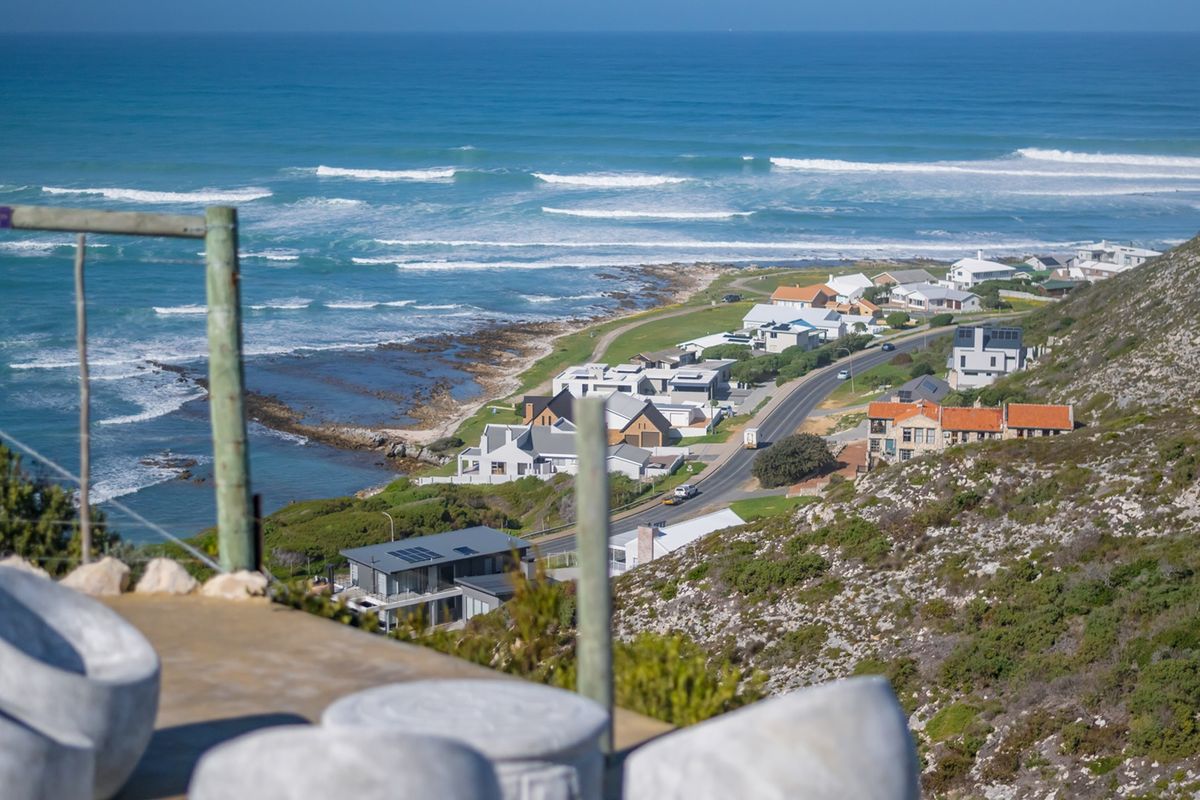 Elevated panoramic view overlooking the coastline, ocean, and surrounding residential properties.