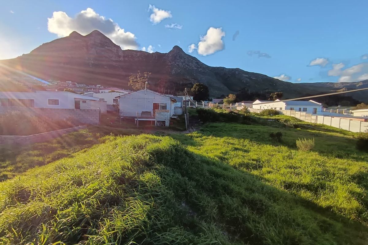 A scenic view of the surrounding landscape featuring open grassland and a prominent mountain backdrop.