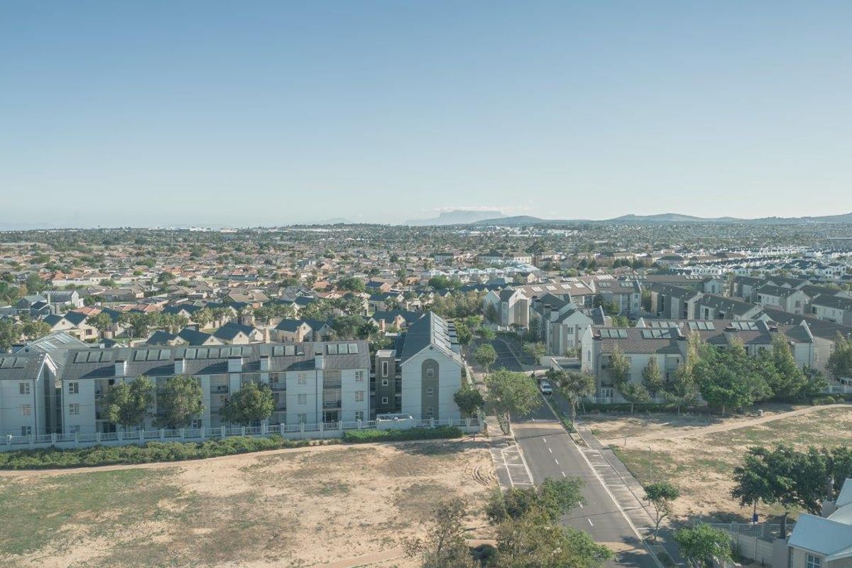An elevated aerial view showcasing the surrounding residential neighborhood and apartment complex layout.