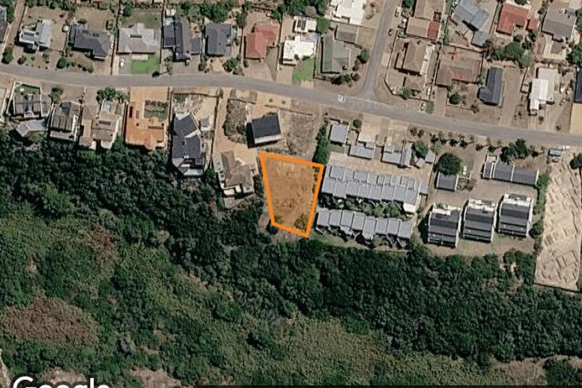 Aerial view of a vacant residential land plot situated in a developed neighborhood, highlighting the property boundaries and surrounding residential context.
