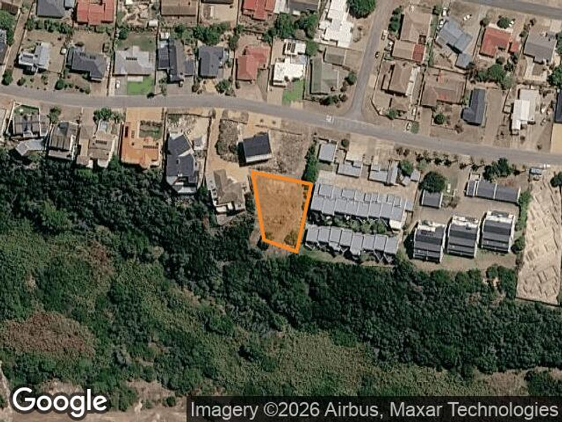 Aerial view of a vacant residential land plot situated in a developed neighborhood, highlighting the property boundaries and surrounding residential context.