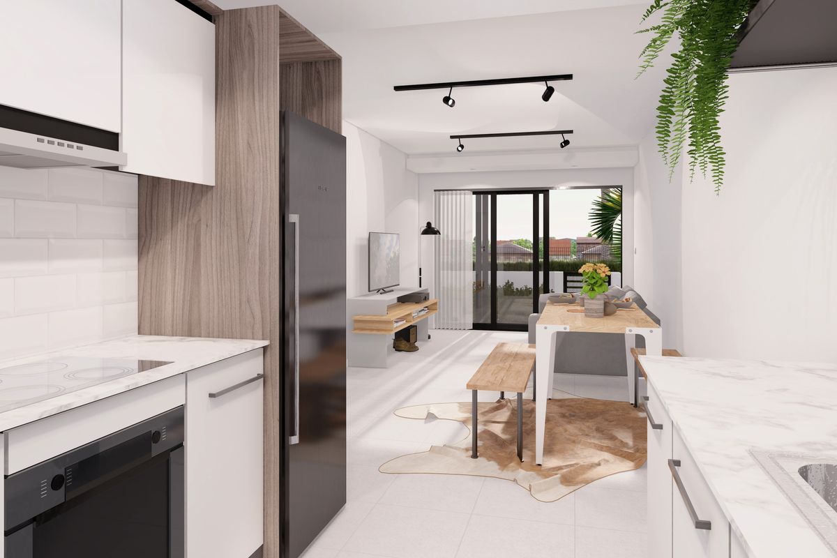 Modern open-plan kitchen and living area featuring contemporary cabinetry, integrated appliances, track lighting, and seamless access to an outdoor balcony.