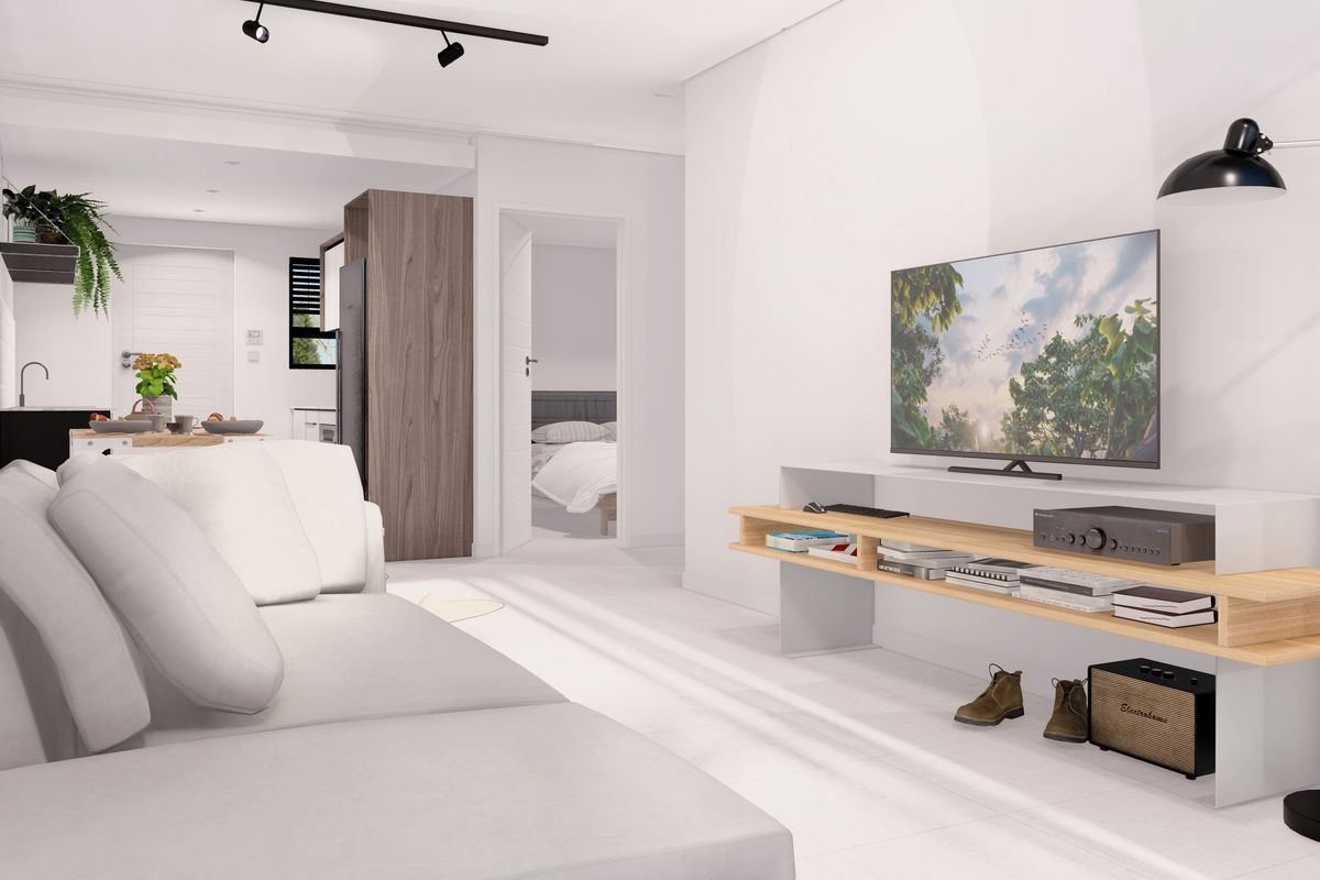 Modern open-plan living area featuring track lighting, neutral finishes, and a seamless transition to the kitchen and bedroom spaces.