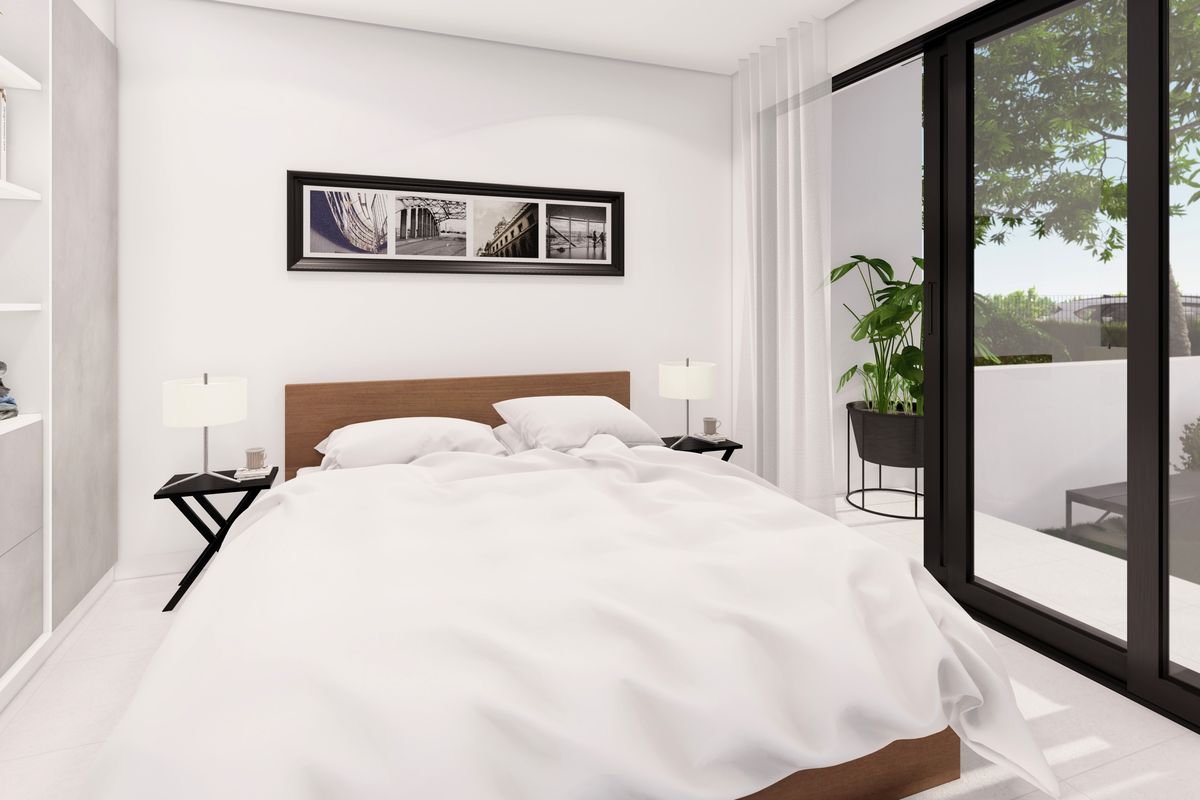 Modern bedroom featuring built-in shelving, sleek tiled flooring, and large sliding glass doors providing access to an outdoor area.
