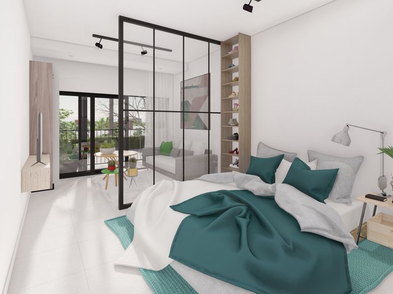Modern bedroom featuring a sleek black metal and glass partition, built-in shelving, track lighting, and direct access to a private balcony.