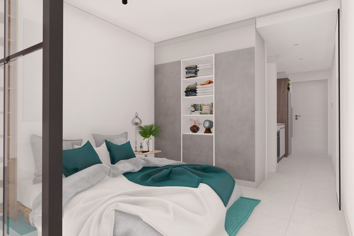 Modern bedroom featuring built-in shelving, sleek tiled flooring, and a contemporary glass partition, creating a bright and open living space.