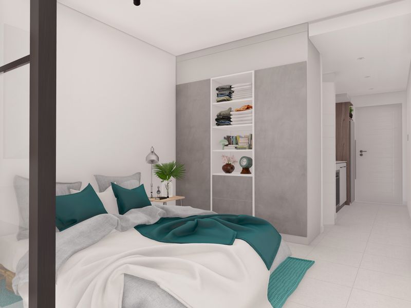 Modern bedroom featuring built-in shelving, sleek tiled flooring, and a contemporary glass partition, creating a bright and open living space.