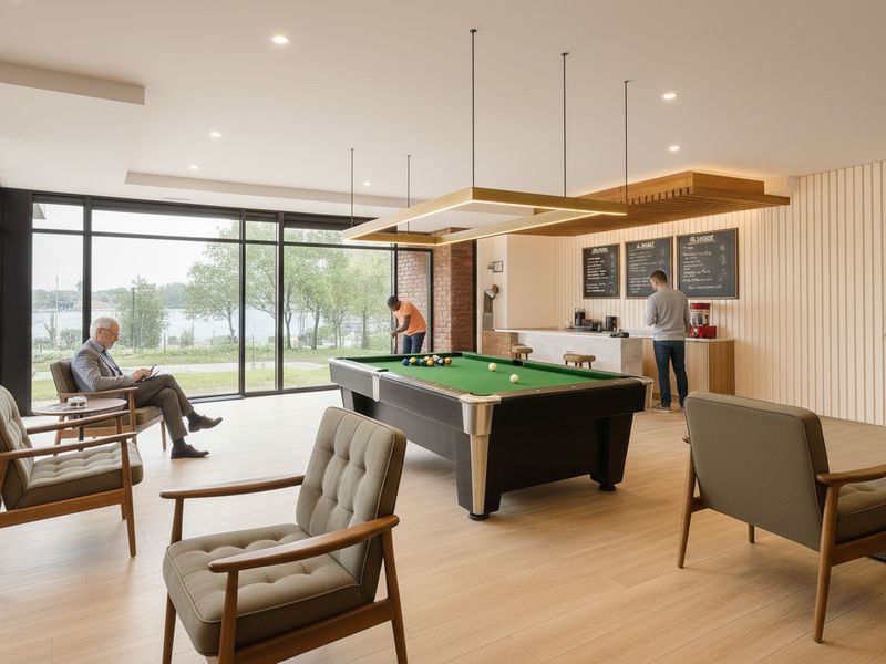 Modern clubhouse lounge featuring floor-to-ceiling windows, a built-in bar area, and contemporary finishes, providing a bright and inviting communal space.