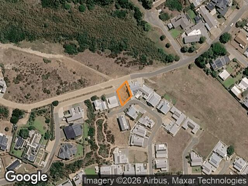 An aerial view showing the vacant residential land plot highlighted within an established suburban neighborhood.
