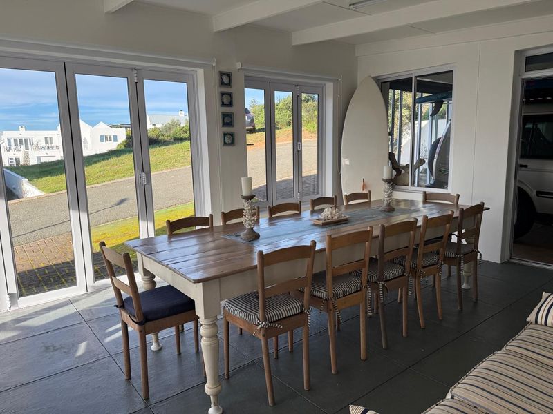Bright dining area featuring large bi-fold doors that provide ample natural light and direct access to the exterior.