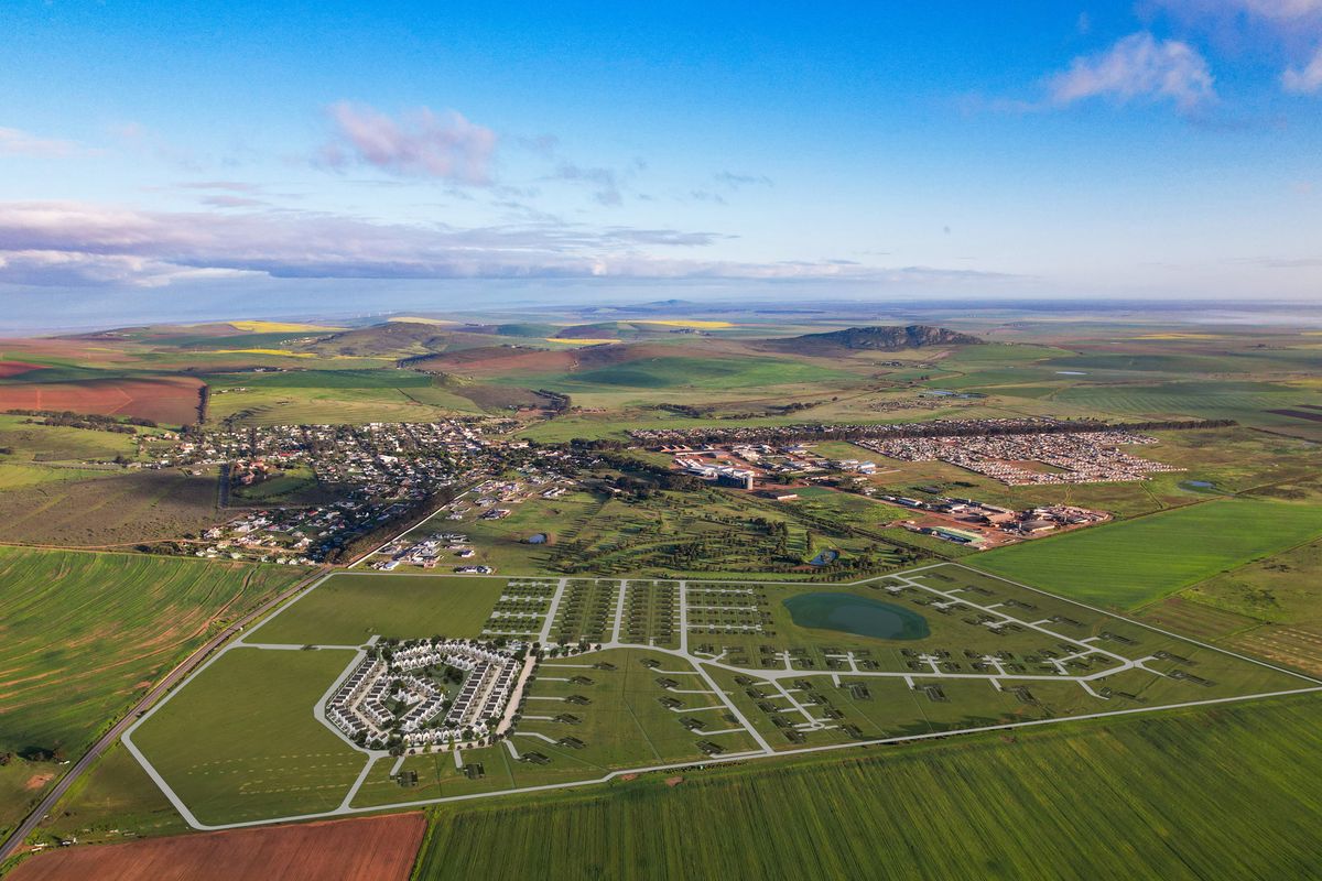 Aerial view of a large-scale retirement village development site, showcasing the planned layout, road infrastructure, and surrounding rural landscape.