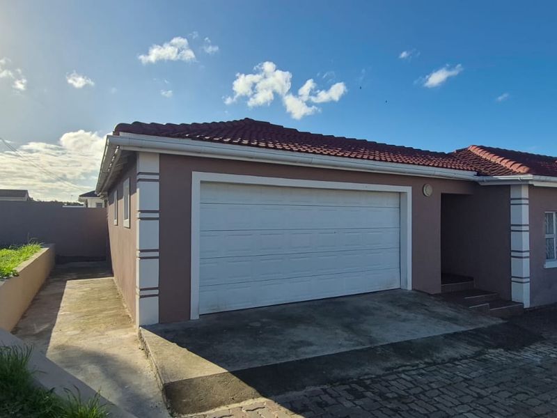 Front exterior view of the house featuring a single garage, paved driveway, and a tiled roof.