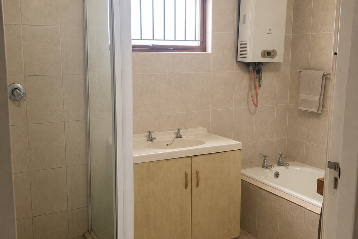 A functional bathroom featuring a separate shower enclosure, bathtub, vanity unit, and wall-mounted gas water heater with neutral tiled finishes.