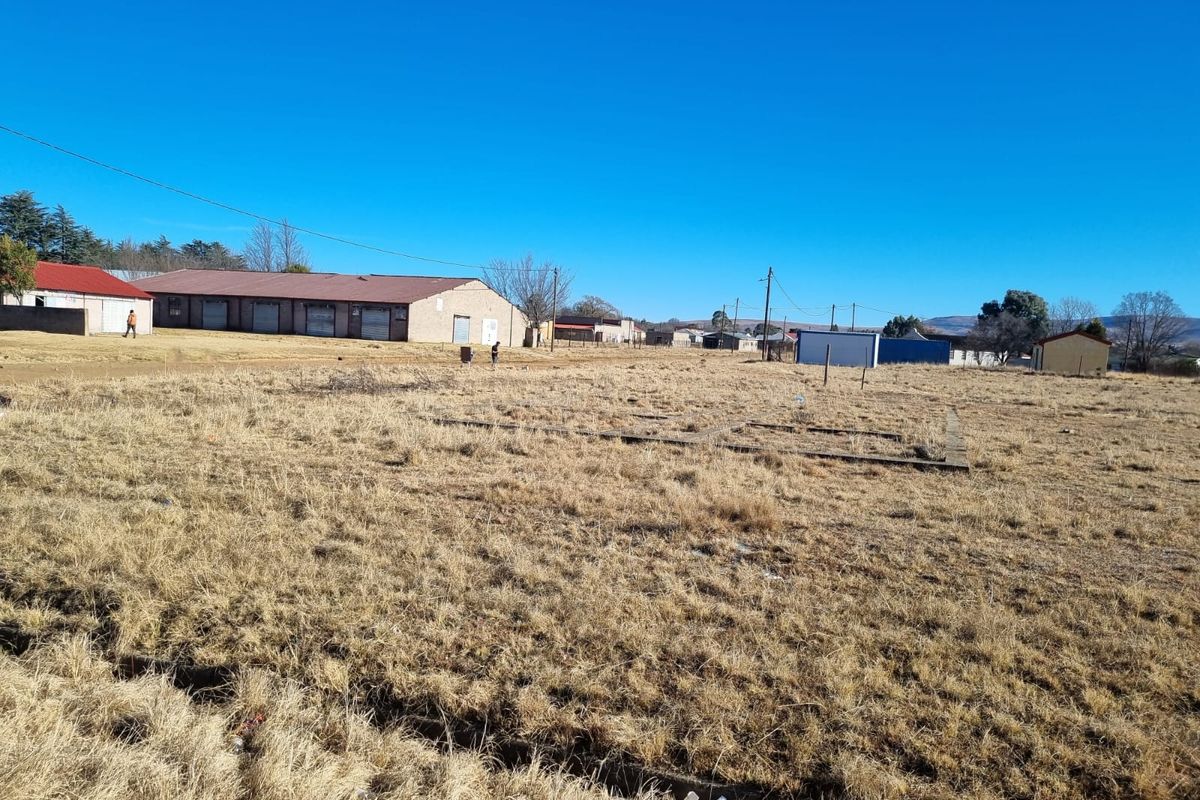 A vacant residential plot featuring a concrete foundation slab, situated in an established neighborhood with surrounding infrastructure.