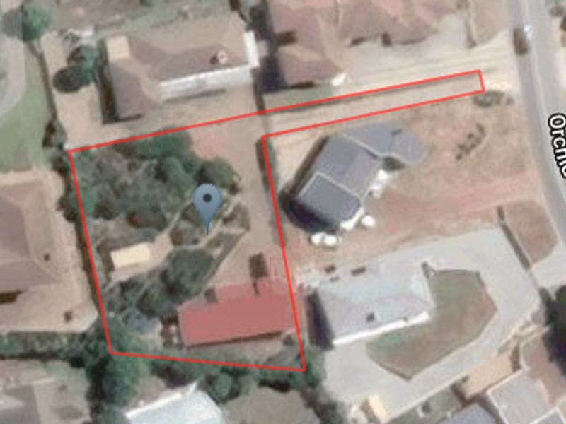 An aerial satellite view showing the property layout, driveway access, and surrounding residential context on Orchid Drive.