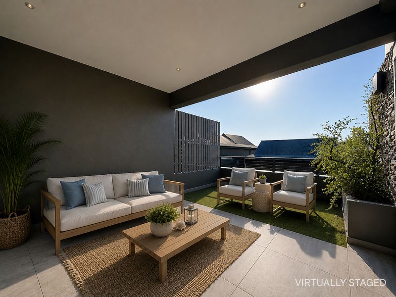 A modern covered balcony featuring tiled flooring, artificial turf, a stone feature wall, and recessed lighting, offering a comfortable outdoor living space.
