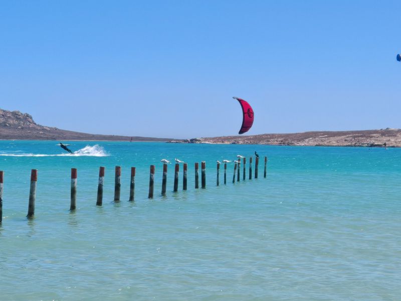 A scenic view of the turquoise lagoon and surrounding landscape, showcasing the natural beauty and recreational potential of the coastal area.