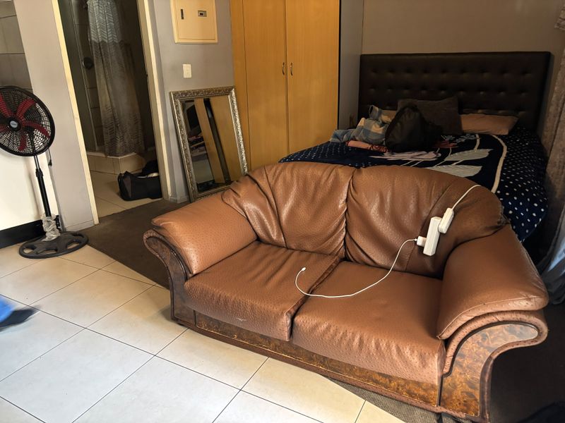 A bedroom featuring tiled flooring, a built-in wardrobe, and direct access to an en-suite bathroom.