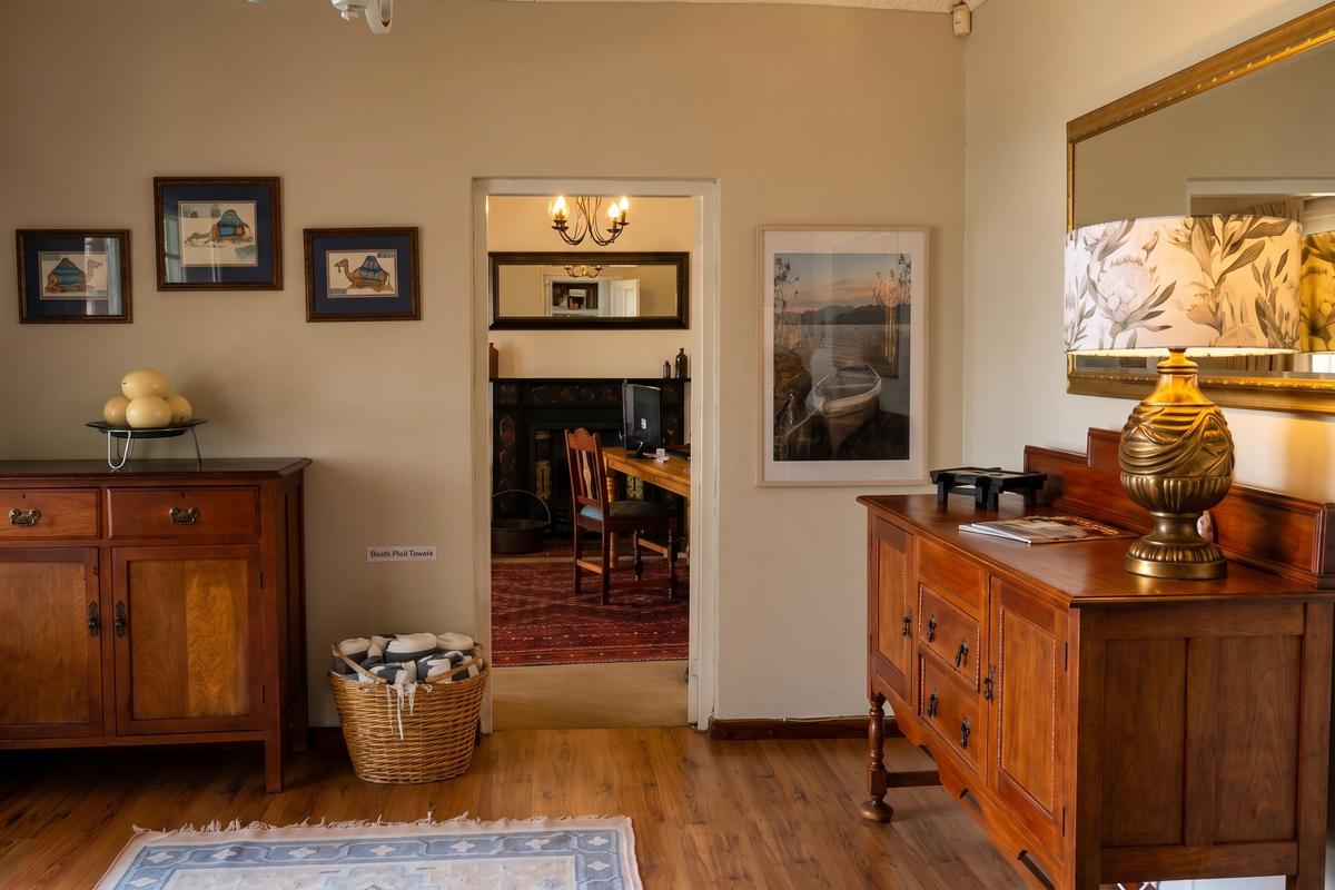 A well-maintained living area featuring warm-toned laminate flooring and neutral wall finishes, providing a comfortable transition space between rooms.