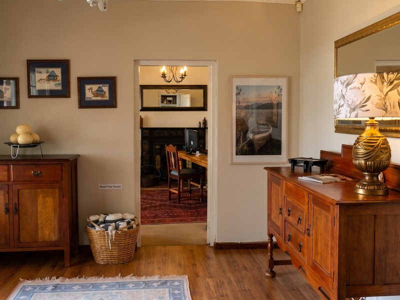 A well-maintained living area featuring warm-toned laminate flooring and neutral wall finishes, providing a comfortable transition space between rooms.