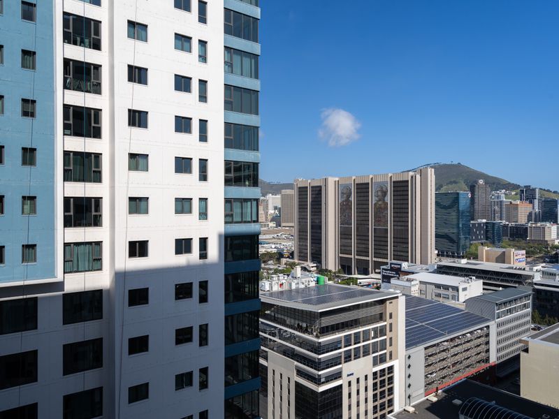 An elevated urban view showcasing the surrounding high-rise architecture and city skyline from an apartment perspective.