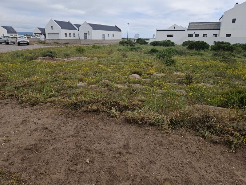 A vacant, unimproved residential plot situated in a developed estate, offering a blank canvas for new construction.