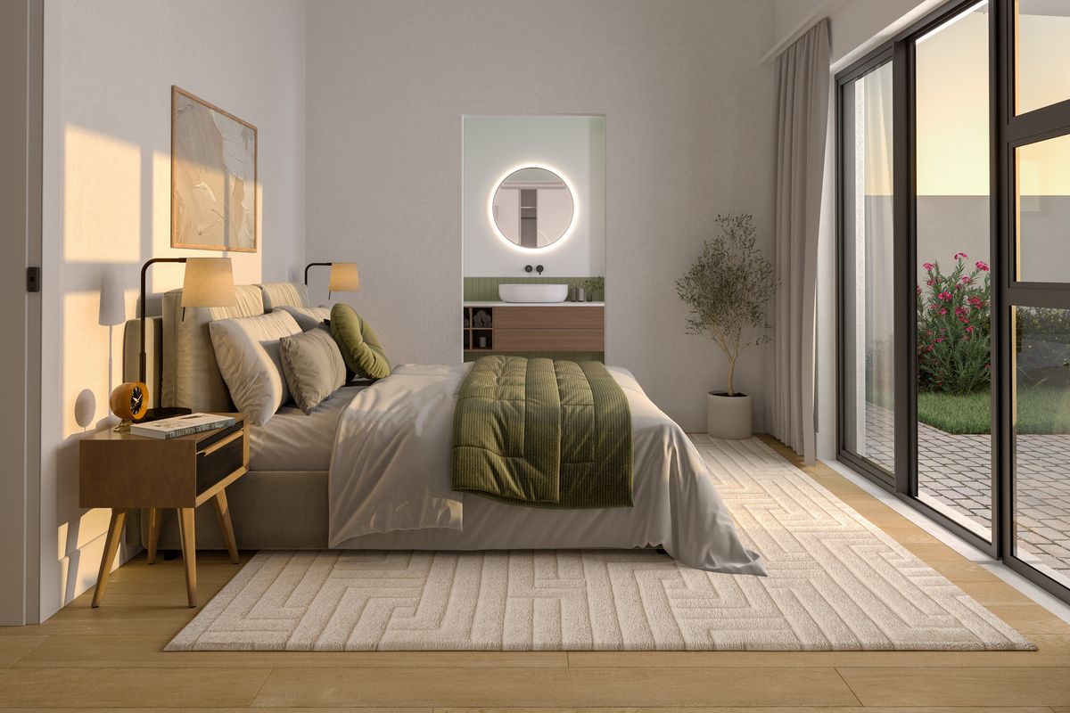 Modern bedroom featuring an en-suite vanity area, large sliding glass doors providing natural light, and high-quality finishes throughout.