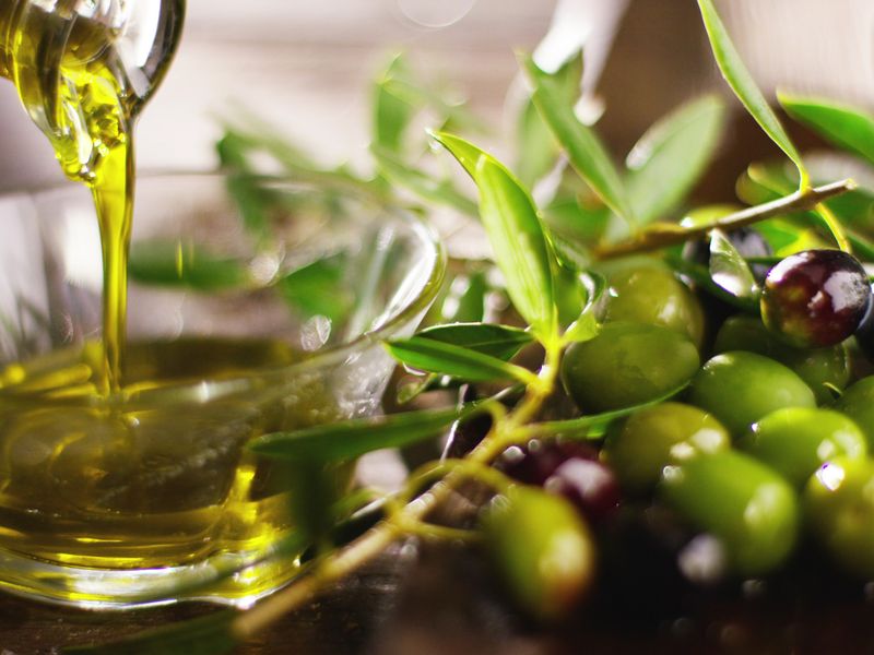 A close-up lifestyle image of olive oil being poured, not depicting any specific property features or architectural elements.