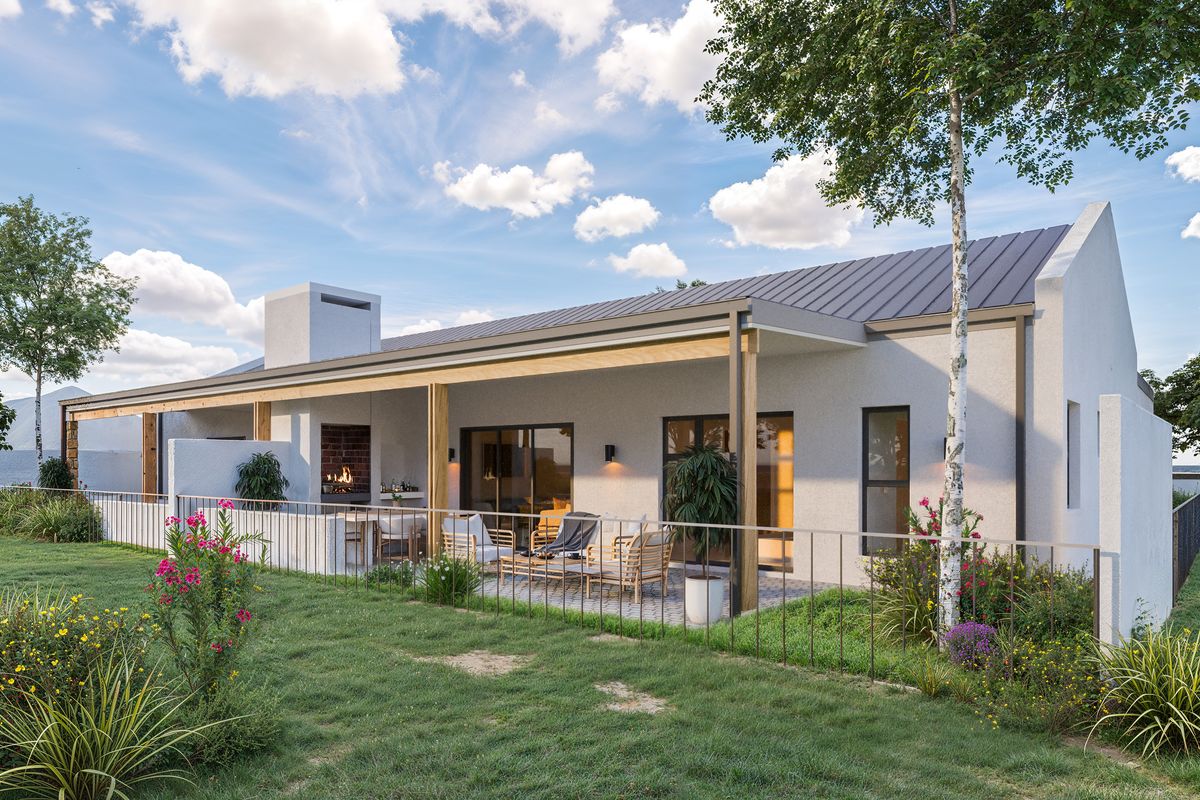 Rear view of a modern townhouse featuring a covered patio with a built-in braai, metal roofing, and landscaped garden area.