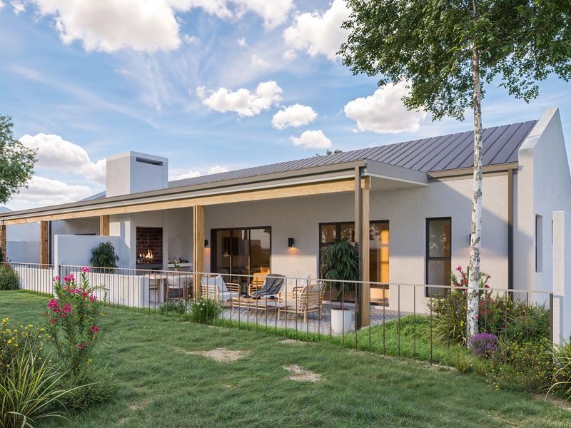 Rear view of a modern townhouse featuring a covered patio with a built-in braai, metal roofing, and landscaped garden area.