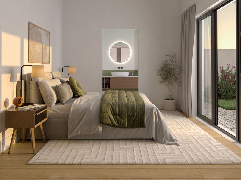 Modern bedroom featuring an en-suite vanity area, large sliding glass doors providing natural light, and high-quality finishes throughout.