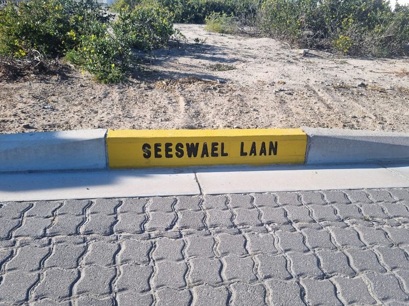 A street view showing the kerb with the street name painted on it, indicating the location of the property.