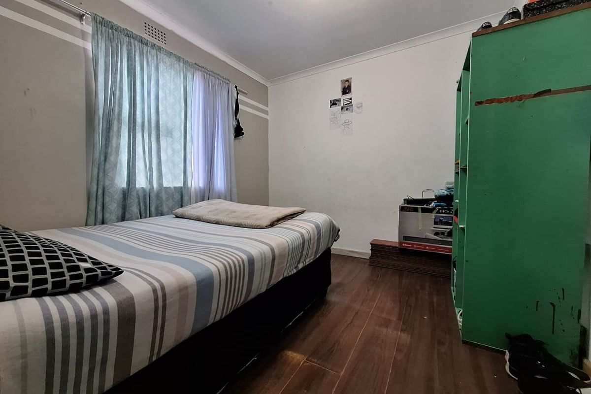 A standard bedroom featuring laminate flooring and neutral wall finishes, offering a functional space ready for cosmetic updates.