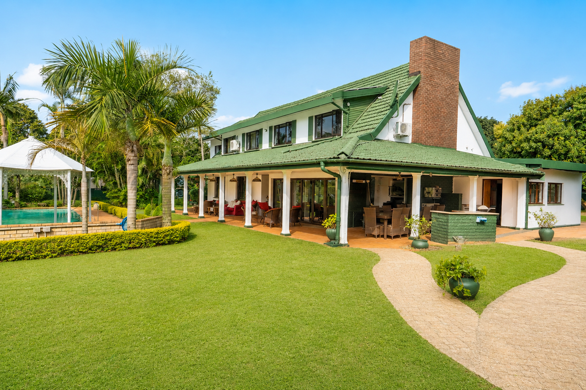 Spacious rear exterior featuring a large covered patio, built-in braai area, swimming pool with gazebo, and a well-maintained landscaped garden.